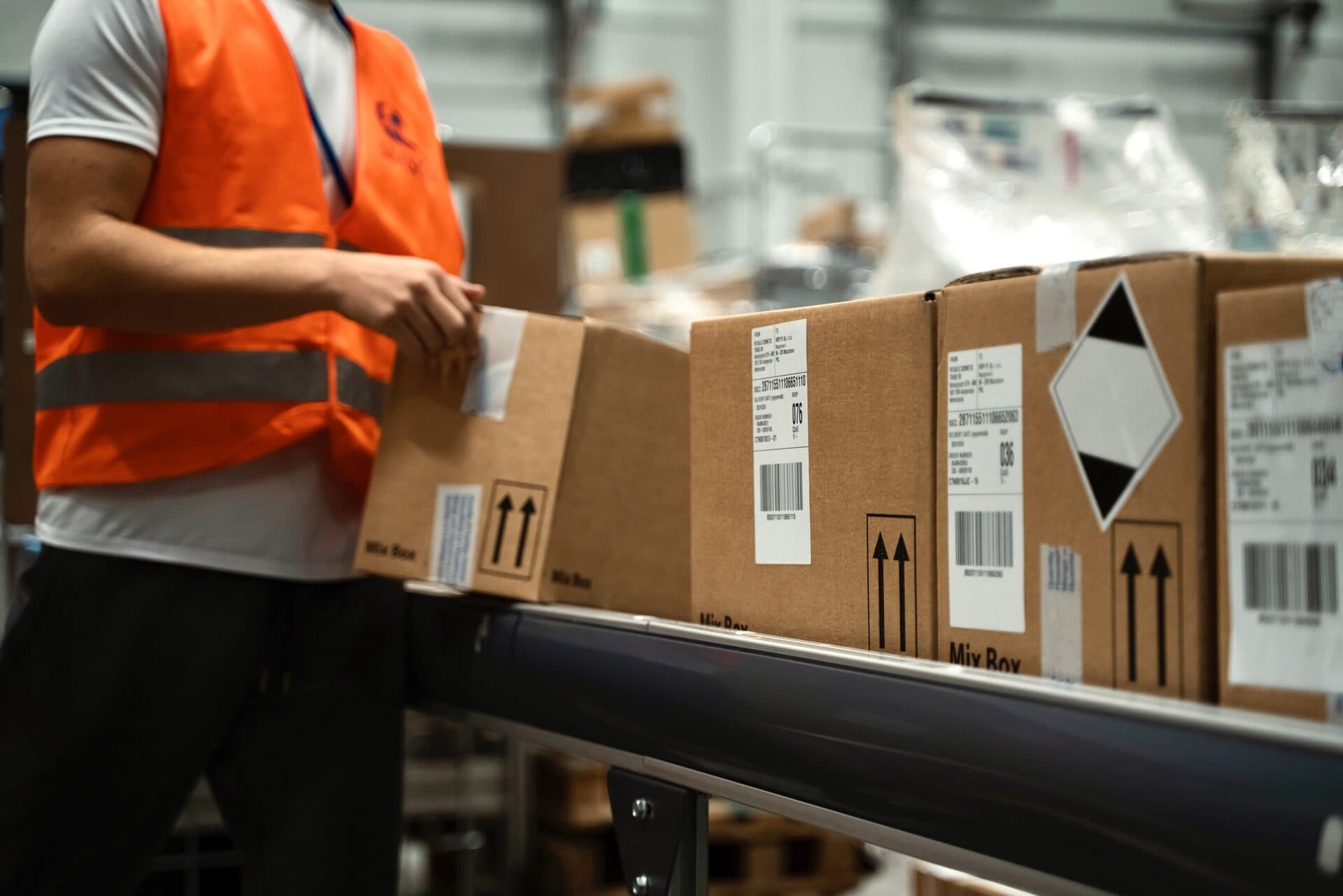 HOPI colleague preparing labelled Mix Box parcels on a conveyor